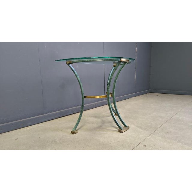 Vintage French console with a green metal and brass frame and a beveled glass top. Beautiful piece inspired by the designs...