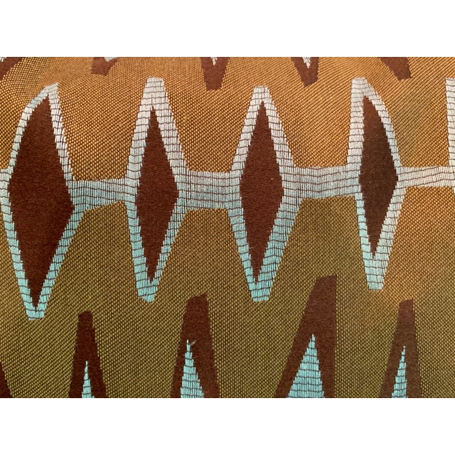 These pillows are constructed from a geometric design satin tapestry in shades of olive green, dark brown, and teal blue...