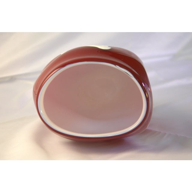 A graphic and heavy-bodied cased art glass vase featuring an all-over "XO" (Hugs and Kisses) motif. The interior is a...