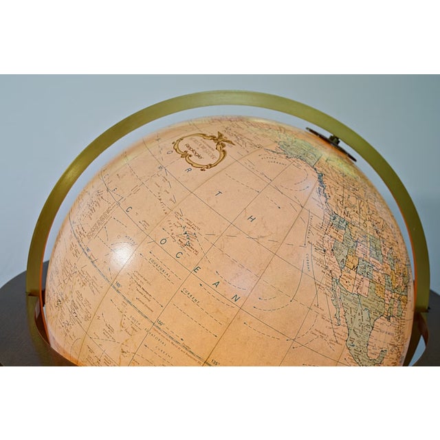 A Replogle "Finley" model lighted Heirloom globe on a mahogany stand. The globe itself has a 20 inch diameter, has subtle...