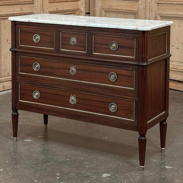 Antique French Louis XVI Mahogany Commode with Carrara Marble will make an elegant addition to any decor! Crafted from...