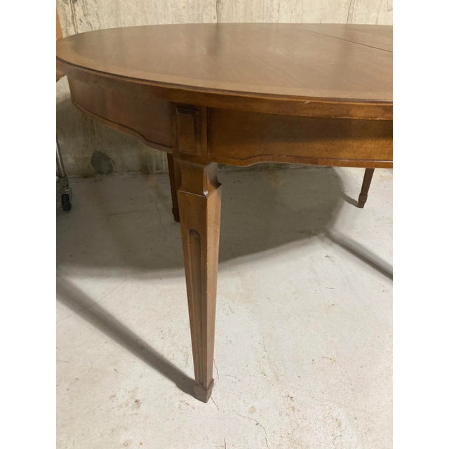 Vintage Henredon oval walnut dining table with banded top. For large or small dining area. Measures 53.5 "W x 45.5"D x...