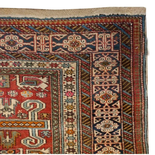 A late 19th century Perepedil rug with a beautiful all-over field of geometric patterns on a crimson background surrounded...