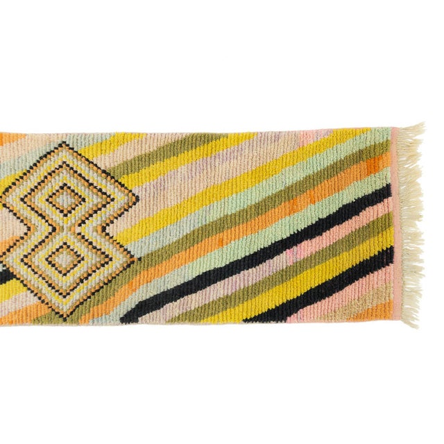 Playful color in motion, woven for narrow spaces. This hand-knotted wool runner features a dynamic diagonal stripe pattern...
