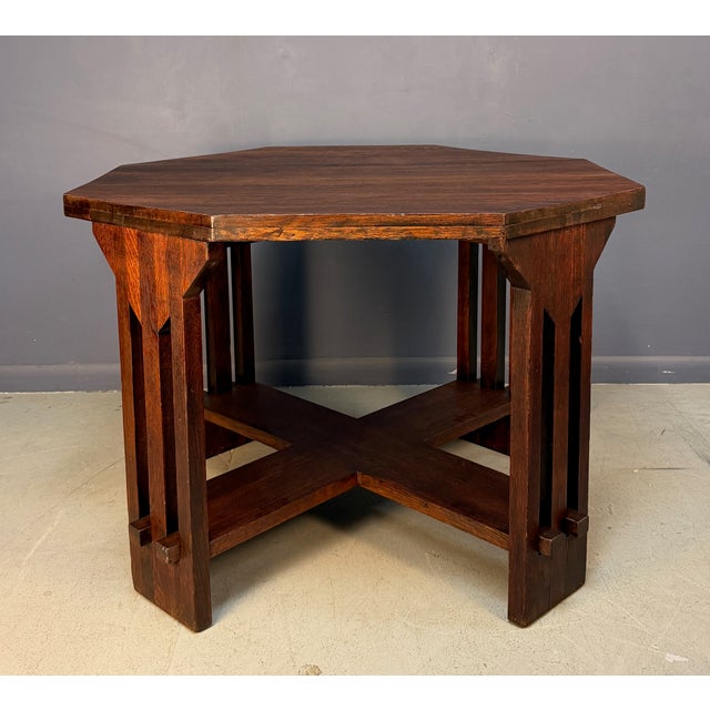 A handsome Arts and Crafts octagonal side table by Brooks, crafted in quarter-sawn oak with the rich, deep patina...