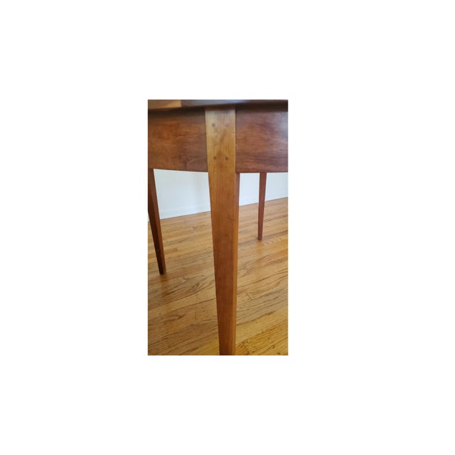 The Thomas Moser Ring Table is a round dining table made of cherry wood with a brown color. This indoor table is 42 inches...