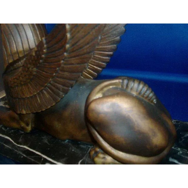 A fine 19th c. bronze recumbent Egyptian sphinx with outswept wings mounted on a marble base. High quality casting and...