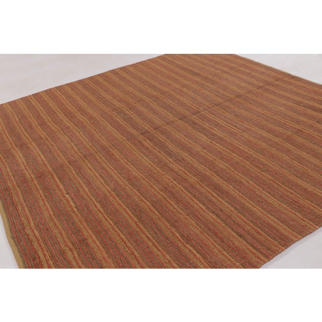 Handwoven in wool and all-natural hemp, this contemporary flat-weave by Rug & Kilim enjoys lustrous tones of golden-beige...