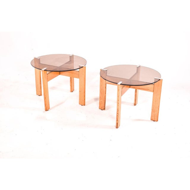 Pair of Portuguese side tables in oak wood, 80's. Top in smoked glass secured by metal parts. Perfect table for decoration...