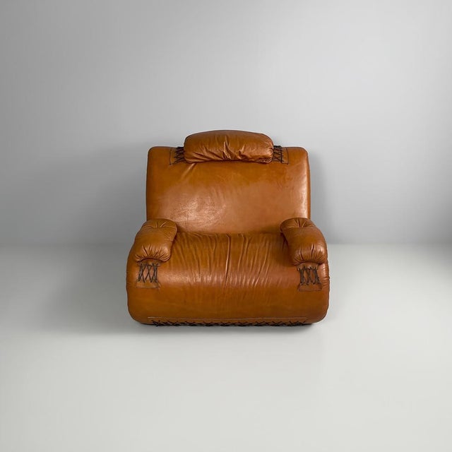 Italian modern brown leather armchairs, 1970s Pair of cognac leather armchairs, distinguished by their soft, flowing...