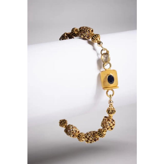 An 18 karat gold beaded bracelet with very unusual hand made beads adding texture and dimension. The push clasp features a...