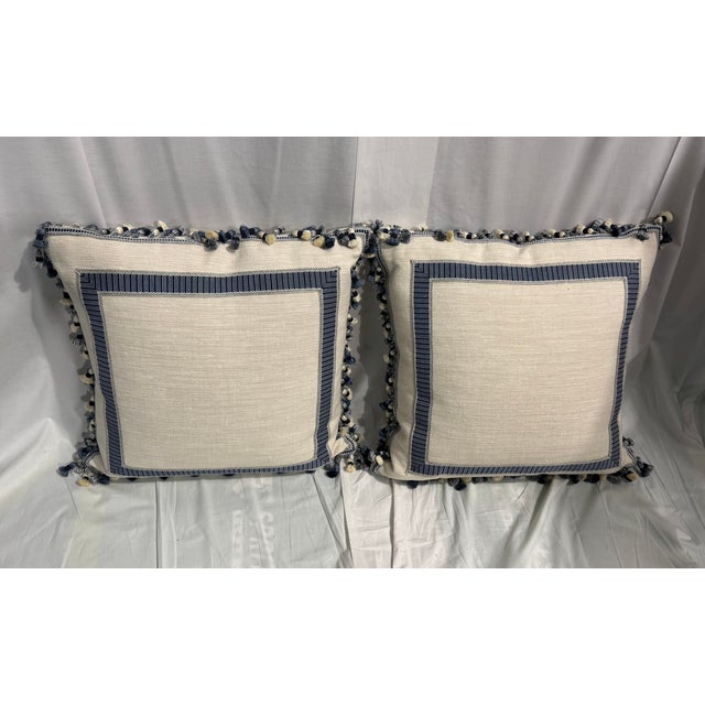 Set of 2 decorative pillows with cute blue tassel border.