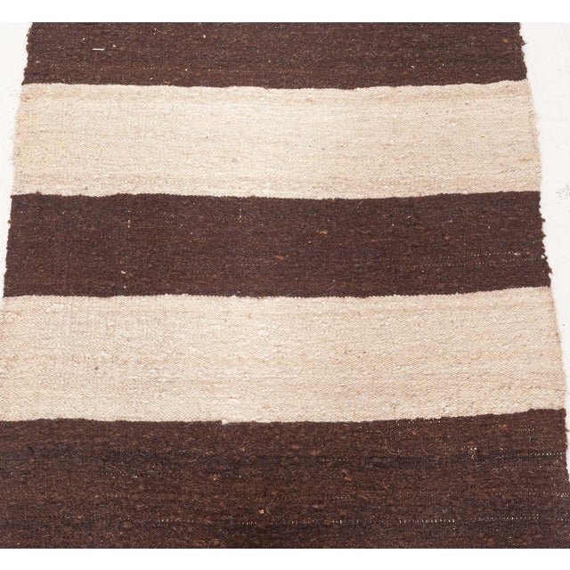 Bold in simplicity and rich in character, this vintage Persian Kilim runner from the 1960s captures the enduring appeal of...
