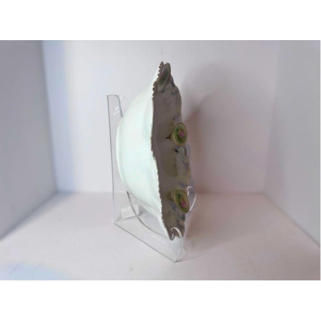 An early‑20th‑century RS Prussia porcelain bowl decorated with five medallions of hand‑painted roses linked by delicate...