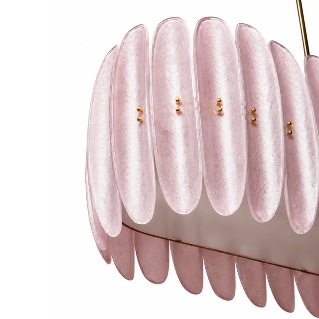 Contemporary Mid-Century style ceiling lamp made with a brass structure and composed of a sequence of pink translucent...