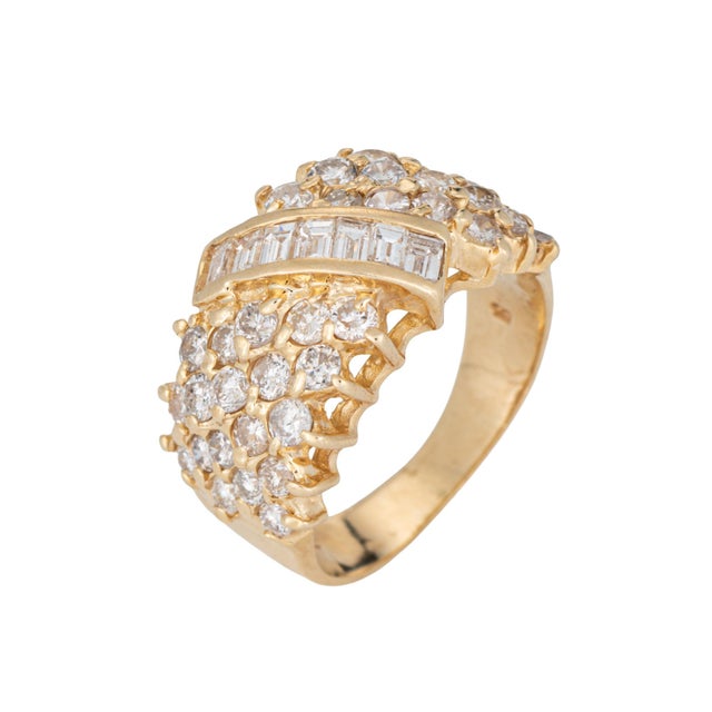 Stylish vintage diamond cigar ring (circa 1980s) crafted in 14 karat yellow gold. Mixed cut diamonds total an estimated...