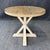 This rustic round side table features a distressed oak plank-style top with visible grain and character markings. The...