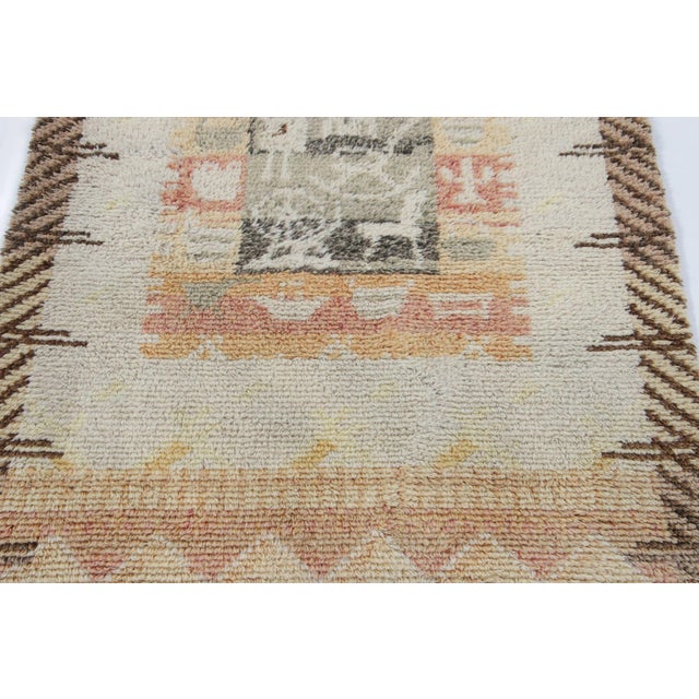 Hand-knotted in lush, high-pile wool in Sweden circa 1960-1970, this 3x4 vintage Swedish Rya rug is a bold new addition to...