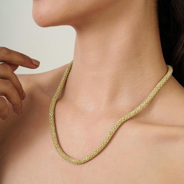 A luminous yellow sapphire tennis necklace crafted in 925 sterling silver, featuring finely set round-cut gemstones...