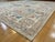 This handmade Afghan rug features a Persian Mahal-inspired floral design with soft pastel tones of sky blue, ivory, taupe,...