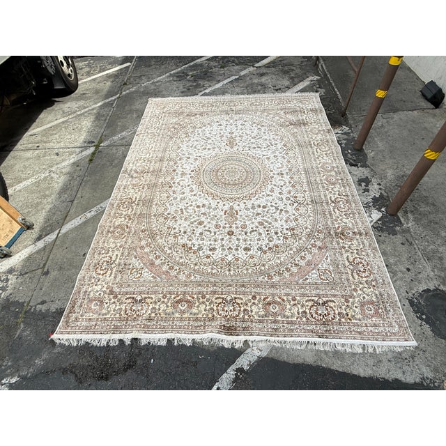 Design Plus Gallery presents a 10ft 1in × 14ft Silk Area Rug. The area rug has a large central medallion that is perfectly...