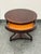 Design Plus Gallery presents an Acquisitions by Henredon Occasional Table. This wood table has a circular top with a...
