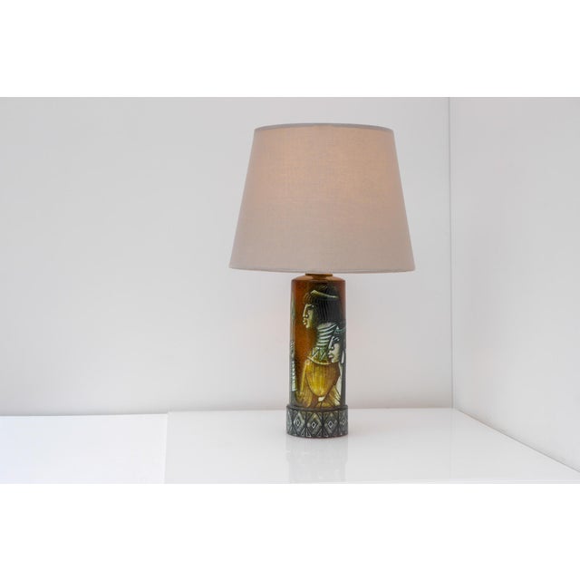 The lamp is finished in one of bonnie rehnqvist's most striking glazes. A rich, deep brown glaze with details in various...