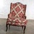 Exquisite vintage French Louis XV style wingback armchair composed of a carved walnut frame with cabriole legs, loose...