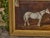 This English oil on canvas painting, dated 1884, captures the quiet elegance of a white horse standing in a dimly lit...