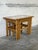 This set of three nesting tables features a convenient space-saving design. Rectangular tops showcase brown scenic tiles...