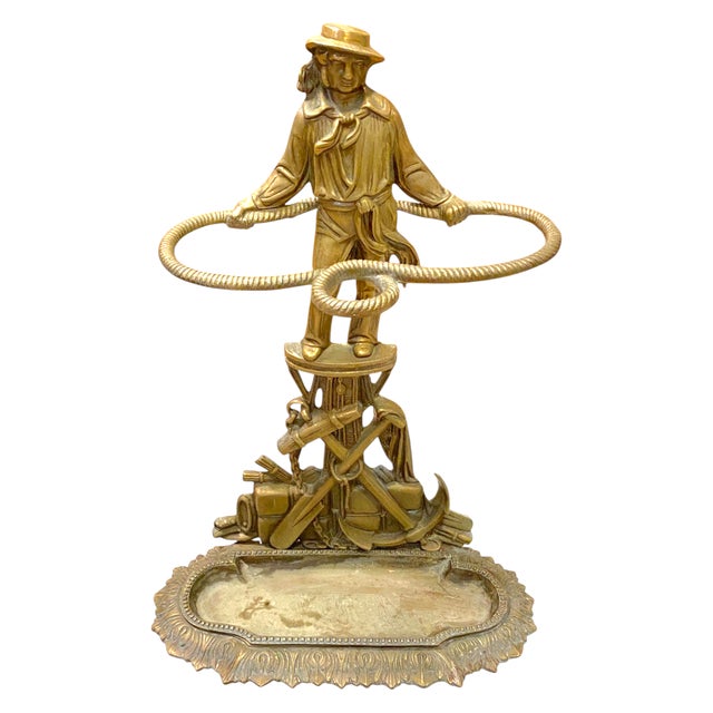A striking early 20th century French gilt-bronze umbrella stand featuring a finely cast sailor (Jack Tar) surrounded by...