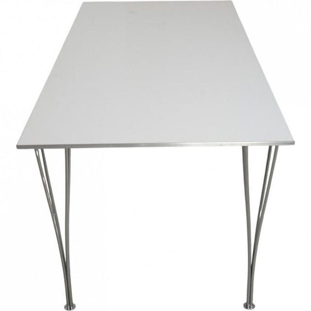 Piet Hein rectangular table with a white laminated tabletop with a steel edge and legs of chrome steel. The table is from...