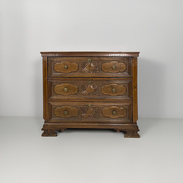 Italian baroque-style wooden chest of drawers, 1930s Dark wood chest of drawers with three stacked drawers. Each drawer...