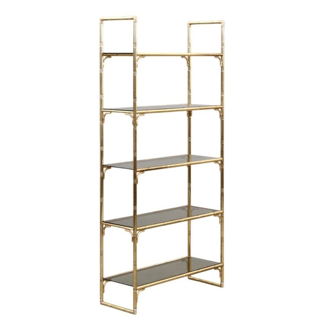 Italian shelving display produced in italy during the 1970s. executed in faux bamboo brass with smoked glass shelves and...