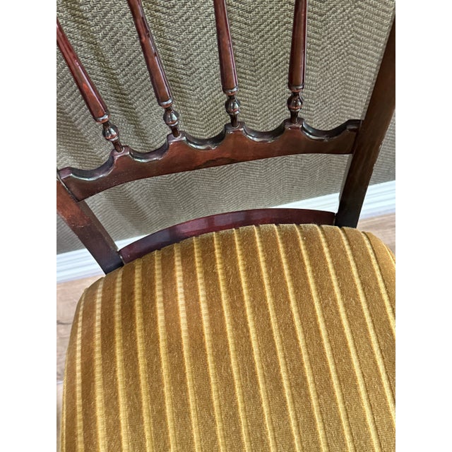A stunning matched set of five French mid-century dining chairs in the classic English Regency taste, crafted under the...