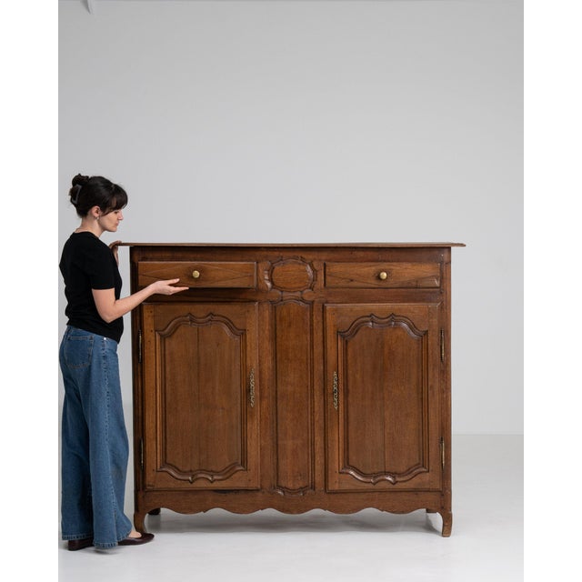 This cabinet makes its impression through dark aged oak, 4 doors, rustic. The piece dates to Early 19th Century, sourced...