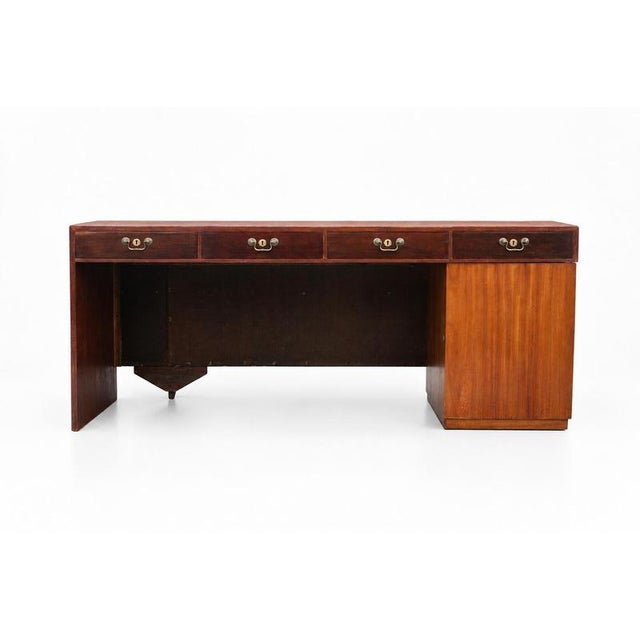 This 2 piece teak-mahogany veneer desk was produced in 1940’s, Sweden. It features 4 drawers with brass handgrips and a...