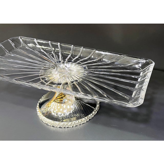 Add a touch of glamour to your table with this hand-assembled rectangular serving stand, combining a crystal-clear...