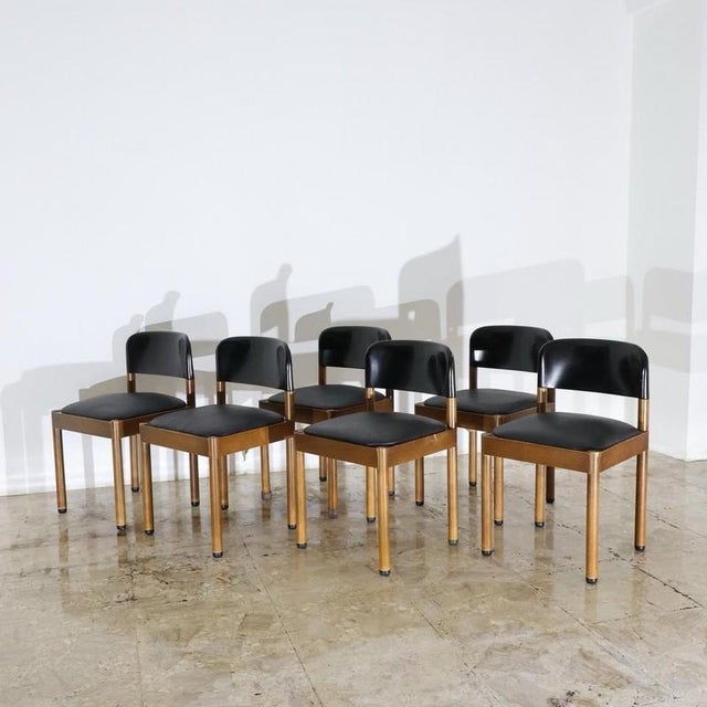 Dining set consisting of 6 wooden chairs with leather seat and black plastic back. Piarotto Production - Italy, 1960s...