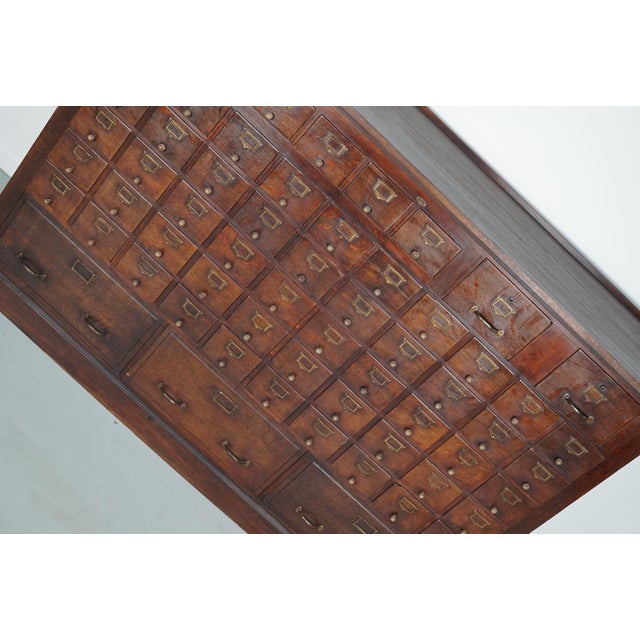 This apothecary / filing cabinet was produced during the 1920/30s in france. It features 61 drawers in three different...