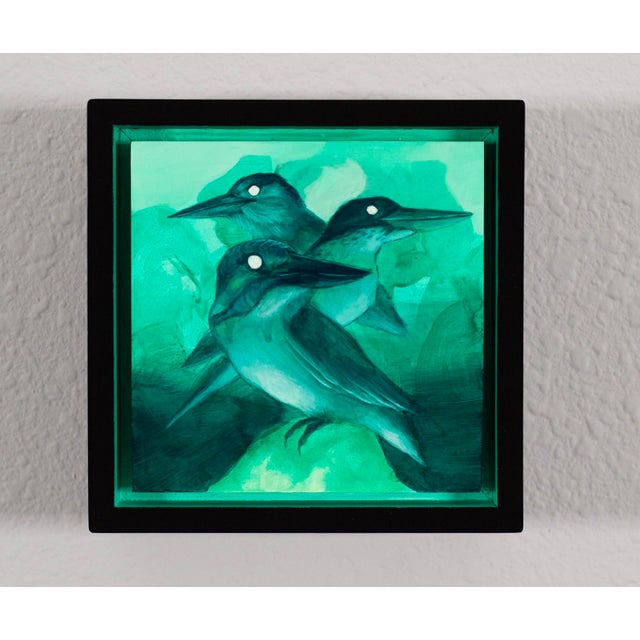This artwork depicts three stylized birds, rendered in a harmonious palette of turquoise and deep greens, set against a...