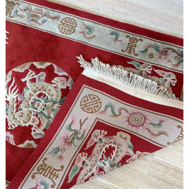 Handmade vintage Art Deco Chinese rug in bright red color and dragon design. The rug is from the middle of 20th century in...