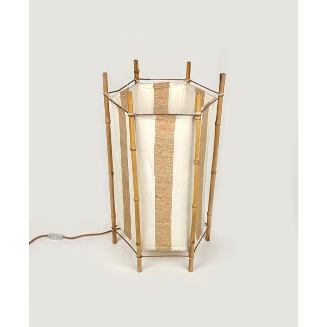 Amazing floor lamp or table lamp in white and brown cotton featuring structure in bamboo composed of six stems in the...