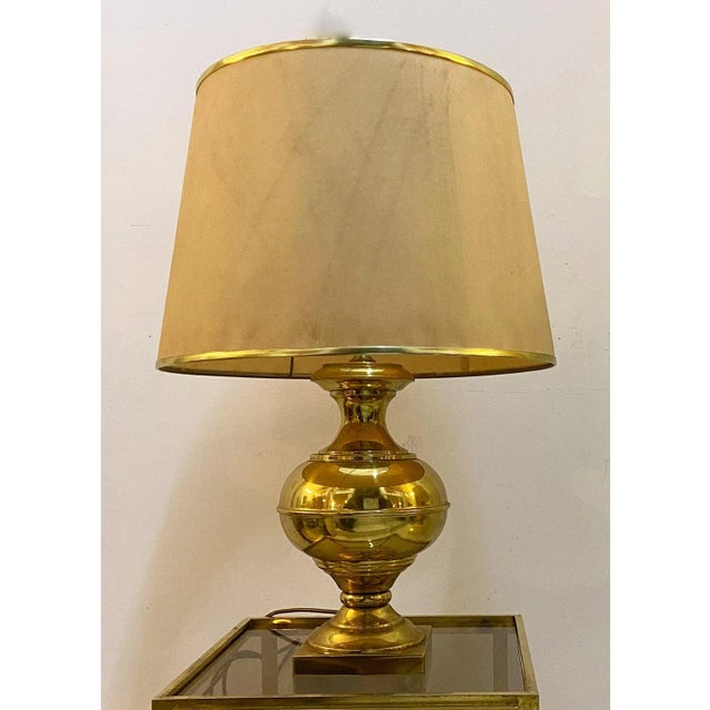 Elegant brass table lamp with polished finish, Italian proeduction of the 60s. Fabric lampshade with brass edges. European...
