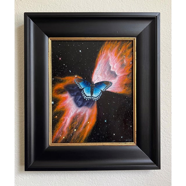 Butterfly Nebula presents a striking juxtaposition of a vibrant blue butterfly set against a cosmic backdrop of swirling...