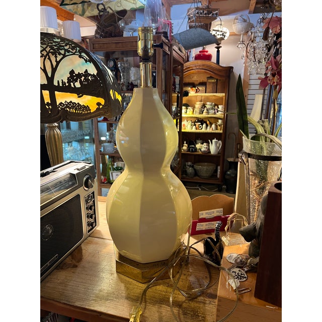 Ceramic cream double gourd table lamp sets on shinny brass chrome octagon base. Measures measures 22” to the top socket ,...