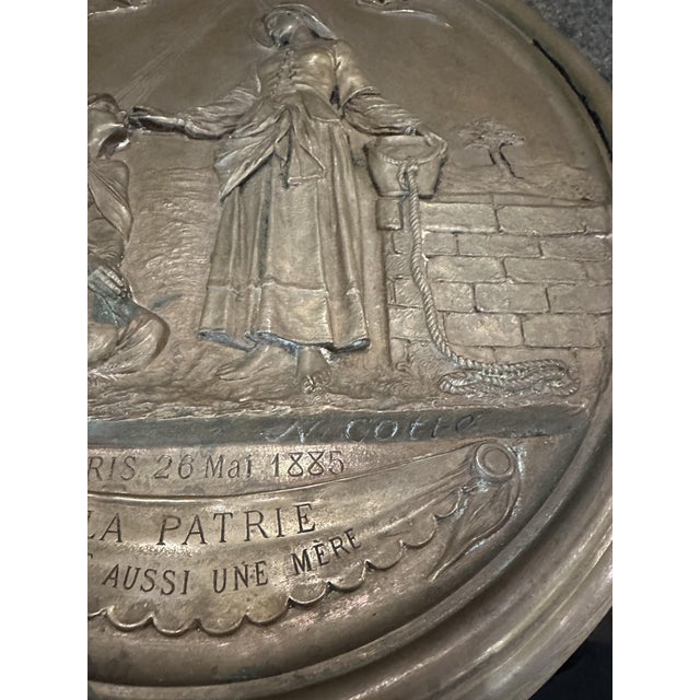 Particular oval bronze plaque dated 1885 signed by the sculptor Narcisse Cotte (1828-1892) and depicting Saint Genevieve...
