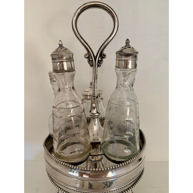 Rare, Victorian rotating caster set with a 5 pieces cruet set: 4 bottles with silver plated lids and a mustard pot also...