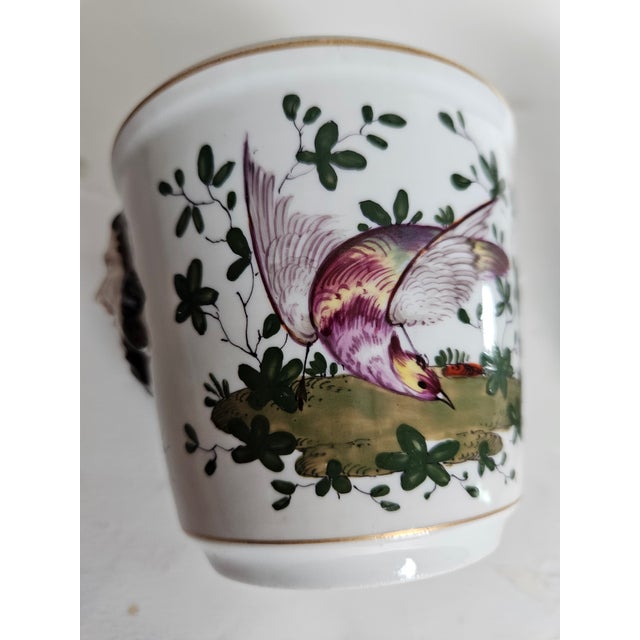 Charming Porcelain cachepots beautifully painted with exotic birds and bugs, with a classical face handles. These are tiny...