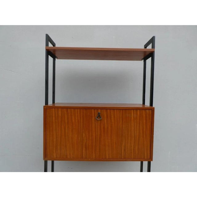 Bookcase with open compartments in Swedish style, with main structure in iron.